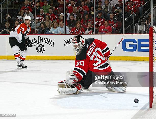 Goaltender Martin Brodeur of the New Jersey Devils makes a save as the puck goes wide of the net on a shot by Daniel Carcillo of the Philadelphia...
