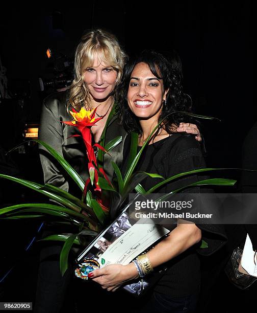 Actress Daryl Hannah and school teacher Kiki Bisbo pose backstage at the Earth Day celebration and screening of Avatar benefitting the Partnership...