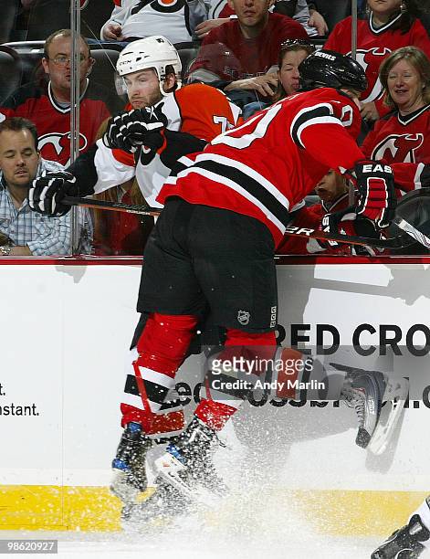Ryan Parent of the Philadelphia Flyers is checked hard into the boards by Rod Pelley of the New Jersey Devils in Game Five of the Eastern Conference...