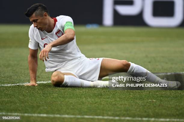 Poland's forward Robert Lewandowski lies on the pitch during the Russia 2018 World Cup Group H football match between Japan and Poland at the...