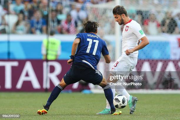 Bartosz Bereszynski Takashi Usami during the 2018 FIFA World Cup Russia group H match between Japan and Poland at Volgograd Arena on June 28, 2018 in...