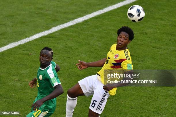 Senegal's forward Sadio Mane and Colombia's midfielder Carlos Sanchez eye the ball during the Russia 2018 World Cup Group H football match between...