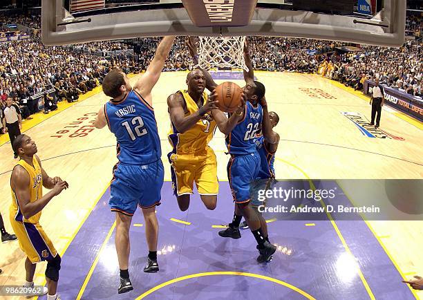 Lamar Odom of the Los Angeles Lakers takes the ball to the basket against Nenad Krstic, Jeff Green and Serge Ibaka of the Oklahoma City Thunder in...