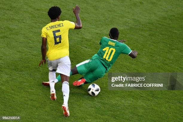 Senegal's forward Sadio Mane falls as vies for the ball with Colombia's midfielder Carlos Sanchez during the Russia 2018 World Cup Group H football...
