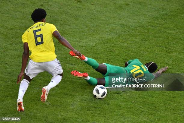 Senegal's forward Sadio Mane falls as vies for the ball with Colombia's midfielder Carlos Sanchez during the Russia 2018 World Cup Group H football...
