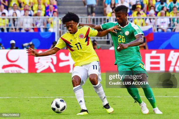 Senegal's forward Keita Balde challenges Colombia's forward Juan Cuadrado during the Russia 2018 World Cup Group H football match between Senegal and...