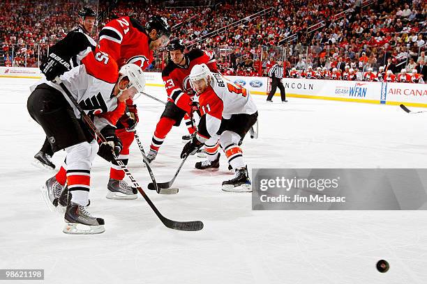 Matt Carle and Blair Betts of the Philadelphia Flyers fight for the puck against Rob Niedermayer and David Clarkson of the New Jersey Devils in Game...