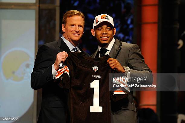 Joe Haden from the Florida Gators poses with NFL Commissioner Roger Goodell as they hold up a Cleveland Browns jersey after he was selected overall...