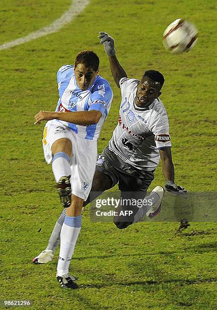 Uruguay's Cerro player Walter Ibanez kicks the ball next to Ecuador's Emelec player Jaime Ayovi during their Libertadores Cup football match at the...