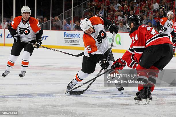 Arron Asham of the Philadelphia Flyers and Bryce Salvador of the New Jersey Devils battle for the puck in Game 5 of the Eastern Conference...