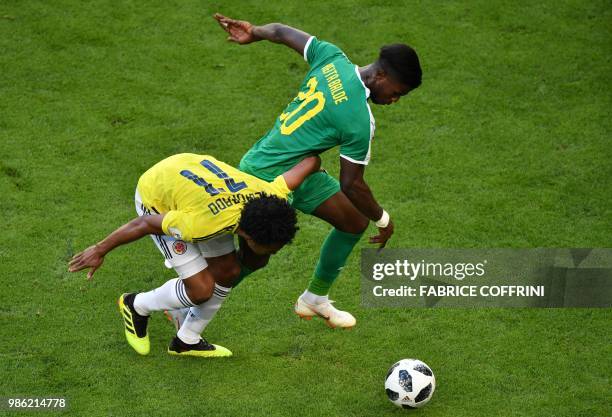 Colombia's forward Juan Cuadrado vies for the ball with Senegal's forward Keita Balde during the Russia 2018 World Cup Group H football match between...