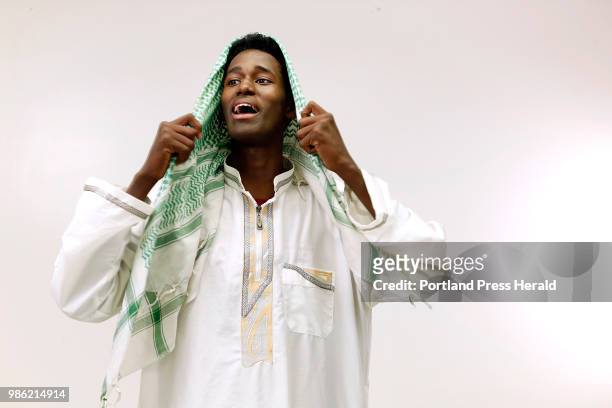 Abas Mohammed adjusts his keffiyeh before attending Eid prayers on Friday at Portland Expo.