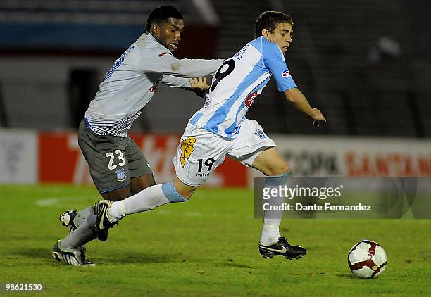 Danilo Asconeguy of Uruguay's Cerro vies for the ball Gabriel Achelier of Ecuador's Emelec during their Libertadores Cup match at the Centenario...