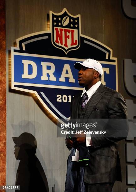 Russell Okung from the Oklahoma State Cowboys walks towards the stage after he was elected overall in the first round by the Seattle Seahawks during...