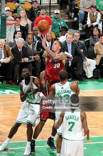 Michael Beasley of the Miami Heat goes up for a shot against Michael Finley, Shelden Williams and Marquis Daniels of the Boston Celtics in Game Two...