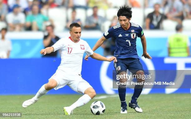 Slawomir Peszko of Poland competes with Gaku Shibasaki of Japan during the 2018 FIFA World Cup Russia group H match between Japan and Poland at...