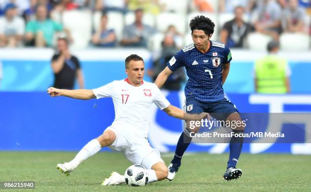 Slawomir Peszko of Poland competes with Gaku Shibasaki of Japan during the 2018 FIFA World Cup Russia group H match between Japan and Poland at...