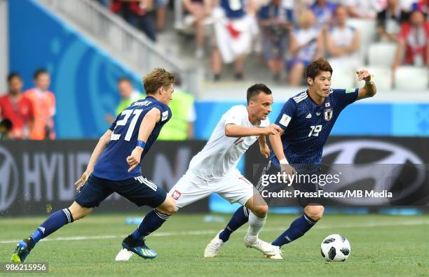 Gotoku Sakai and Hiroki Sakai of Japan competes with Slawomir Peszko of Poland during the 2018 FIFA World Cup Russia group H match between Japan and...