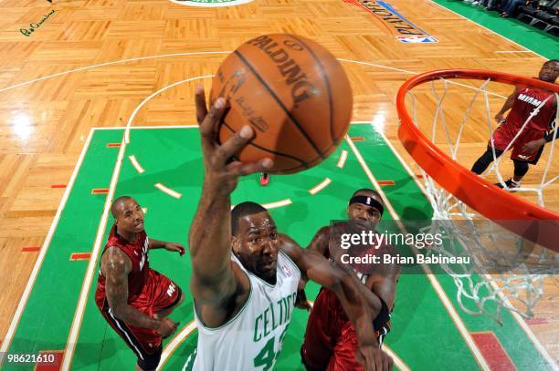 Kendrick Perkins of the Boston Celtics shoots a layup against Jermaine O'Neal and Quentin Richardson of the Miami Heat in Game Two of the Eastern...