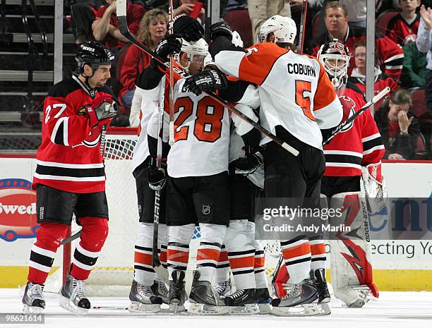 Claude Giroux of the Philadelphia Flyers is congratulated by his teammates after scoring a second-period goal as Mike Mottau and Martin Brodeur of...