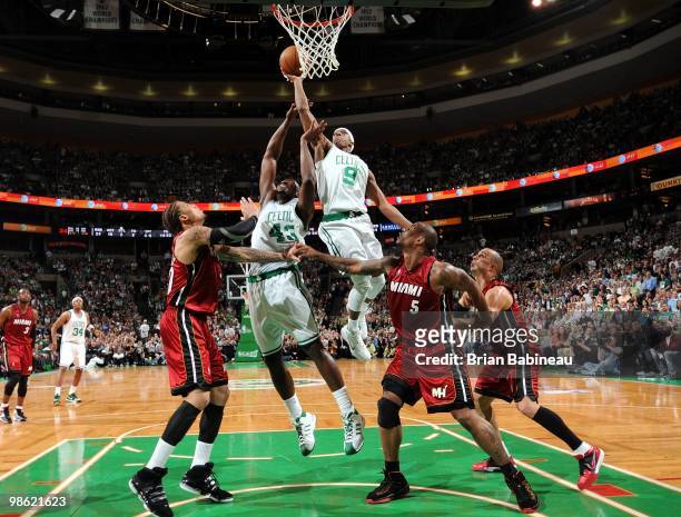Rajon Rondo of the Boston Celtics goes up for a shot against Michael Beasley, Quentin Richardson and Carlos Arroyo of the Miami Heat in Game Two of...