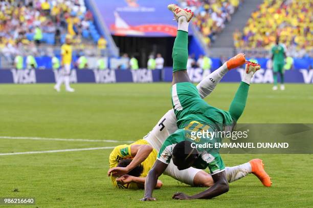 Senegal's forward Sadio Mane falls over Colombia's defender Santiago Arias during the Russia 2018 World Cup Group H football match between Senegal...