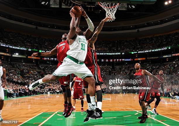 Glen Davis of the Boston Celtics goes up for a shot against Jermaine O'Neal and Michael Beasley of the Miami Heat in Game Two of the Eastern...