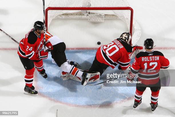 Danny Briere of the Philadelphia Flyers scores a first-period power play goal against goaltender Martin Brodeur of the New Jersey Devils as Bryce...