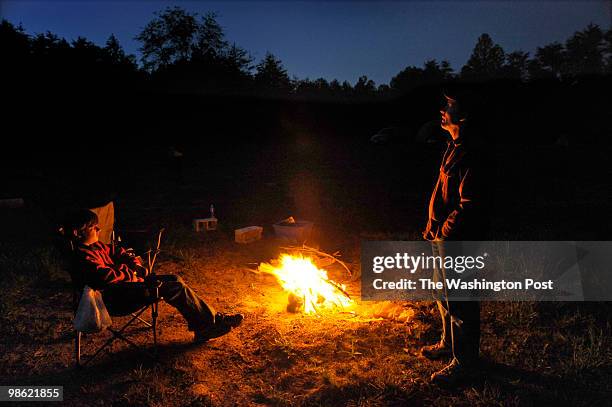 Shaun Klebold enjoys a campfire with his son Collin at the Appleseed Project event. They camped overnight at the gun range which was the site of the...