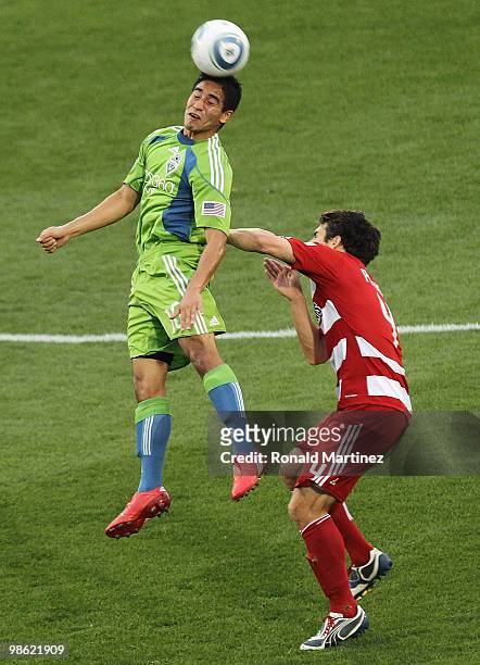 Midfielder David Estrada of the Seattle Sounders heads the ball against Heath Pearce of FC Dallas at Pizza Hut Park on April 22, 2010 in Frisco,...