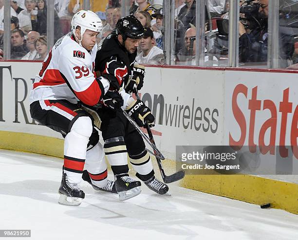 Craig Adams of the Pittsburgh Penguins battles for the puck against Matt Carkner of the Ottawa Senators in Game Five of the Eastern Conference...
