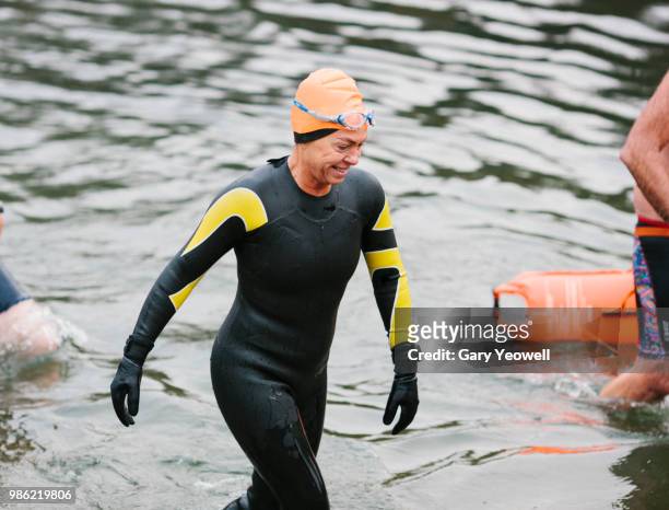 female open water swimmer competing in a swimming event - gary balance foto e immagini stock