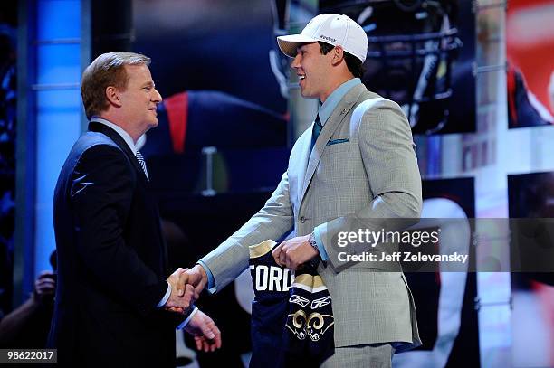 Quarterback Sam Bradford from the Oklahoma Sooners greets NFL Commissioner Roger Goodell after Bradford was selected number 1 overall by the St....