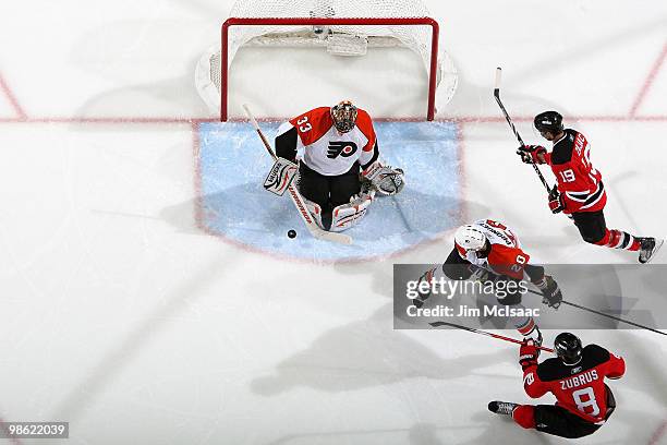 Brian Boucher of the Philadelphia Flyers makes a save against Dainius Zubrus and Travis Zajac of the New Jersey Devils in Game 5 of the Eastern...