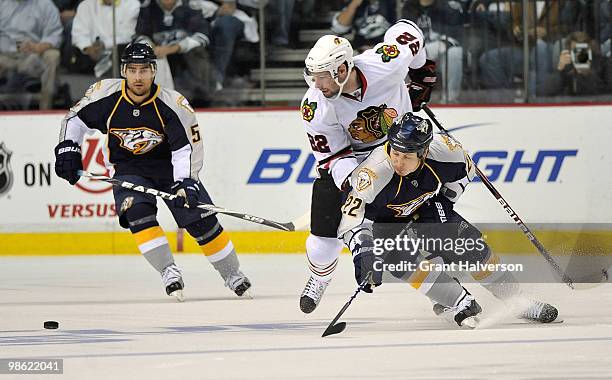 Jordin Tootoo of the Nashville Predators battles Troy Brouwer of the Chicago Blackhawks for the puck in Game Four of the Eastern Conference...