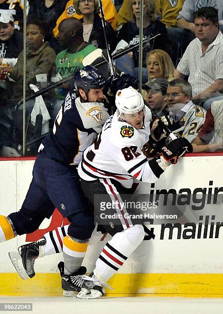 Shea Weber of the Nashville Predators checks Tomas Kopecky of the Chicago Blackhawks in Game Four of the Eastern Conference Quarterfinals during the...