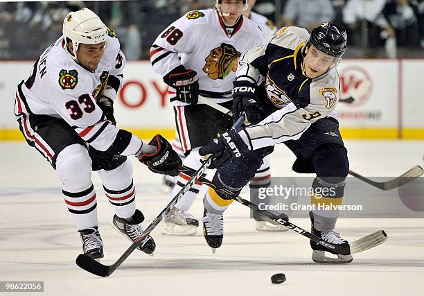 Marcel Goc of the Nashville Predators battles Dustin Byfuglien of the Chicago Blackhawks for the puck in Game Four of the Eastern Conference...