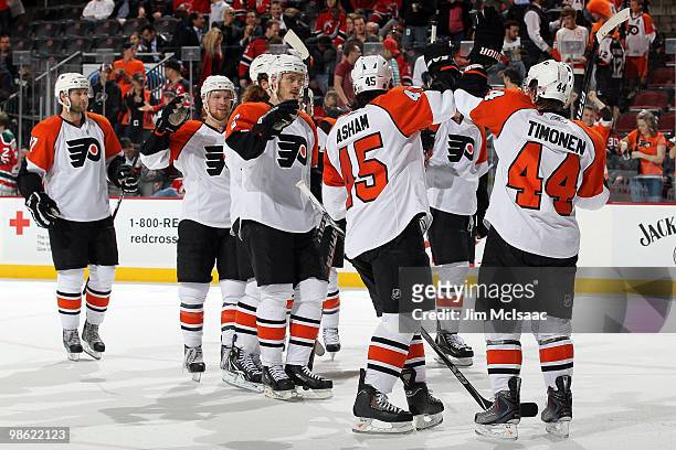 Kimmo Timonen and Arron Asham of the Philadelphia Flyers celebrate after defeating the New Jersey Devils by the score of 3-0 to win in Game 5 of the...