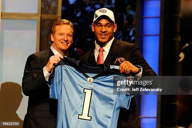 Derrick Morgan from the Georgia Tech Yellow Jackets poses with NFL Commissioner Roger Goodell as they hold up a Tennessee Titans jersey after the...