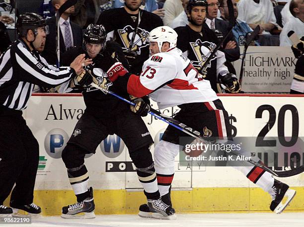 Jarkko Ruutu of the Ottawa Senators hits Alex Goligoski of the Pittsburgh Penguins in Game Five of the Eastern Conference Quarterfinals during the...