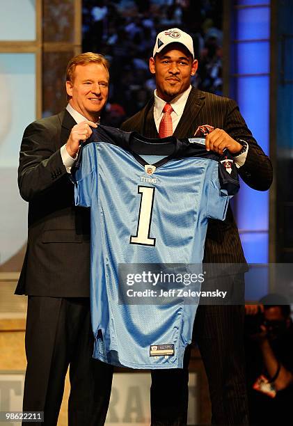 Derrick Morgan from the Georgia Tech Yellow Jackets poses with NFL Commissioner Roger Goodell as they hold up a Tennessee Titans jersey after the...