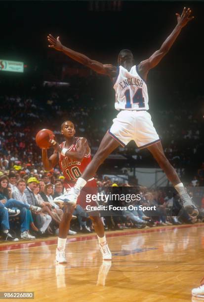 Armstrong of the Chicago Bulls looks to pass the ball past A.J. English of the Washington Bullets during an NBA basketball game circa 1990 at the...