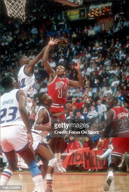 Armstrong of the Chicago Bulls shoots over Harvey Grant of the Washington Bullets during an NBA basketball game circa 1990 at the Capital Centre in...