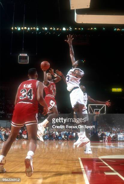 Armstrong of the Chicago Bulls looks to get his shot off over the outstretched arm of Charles Jones of the Washington Bullets during an NBA...