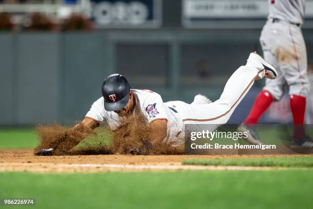 Eduardo Escobar of the Minnesota Twins slides against the Boston Red Sox on June 19, 2018 at Target Field in Minneapolis, Minnesota. The Twins...