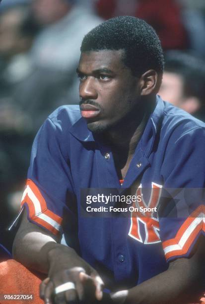 Bernard King of the New York Knicks looks on from the bench against the Washington Bullets during an NBA basketball game circa 1984 at the Capital...