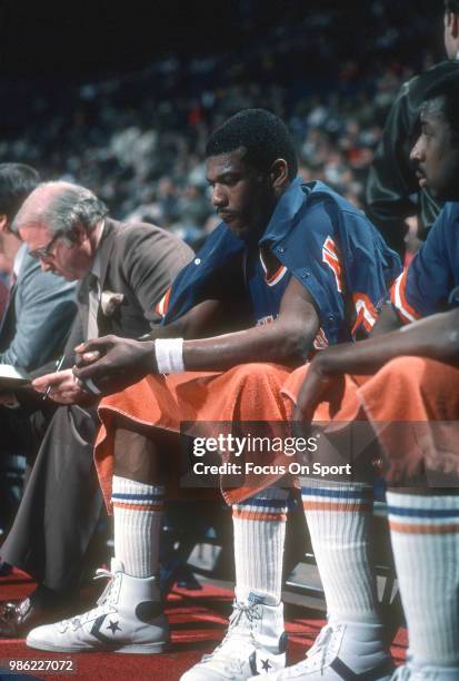 Bernard King of the New York Knicks looks on from the bench against the Washington Bullets during an NBA basketball game circa 1984 at the Capital...