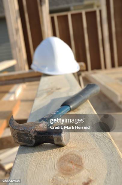 claw hammer and hard hat on board - claw mark stock pictures, royalty-free photos & images
