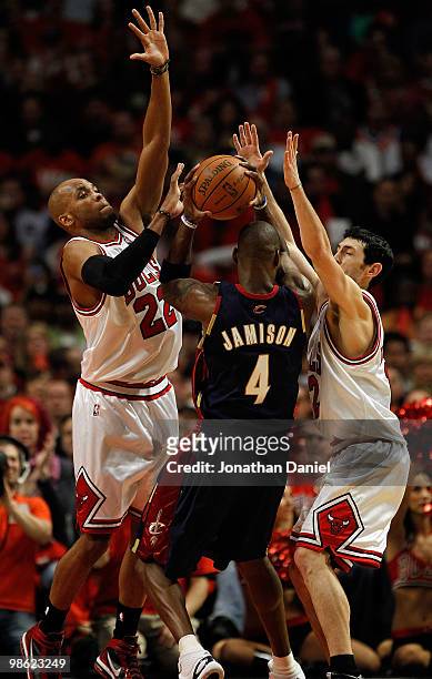 Taj Gibson and Kirk Hinrich of the Chicago Bulls defend against Antawn Jamison of the Cleveland Cavaliers in Game Three of the Eastern Conference...