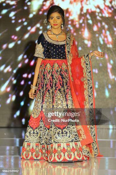 Indian model wearing an elegant and ornate outfit during a South Asian bridal fashion show held in Scarborough, Ontario, Canada.